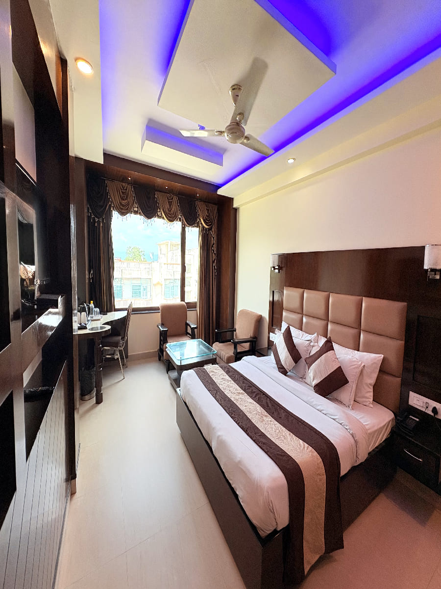 Comfortable room at our hotels in Haridwar near har ki pauri ganga ghat with a cozy seating area
